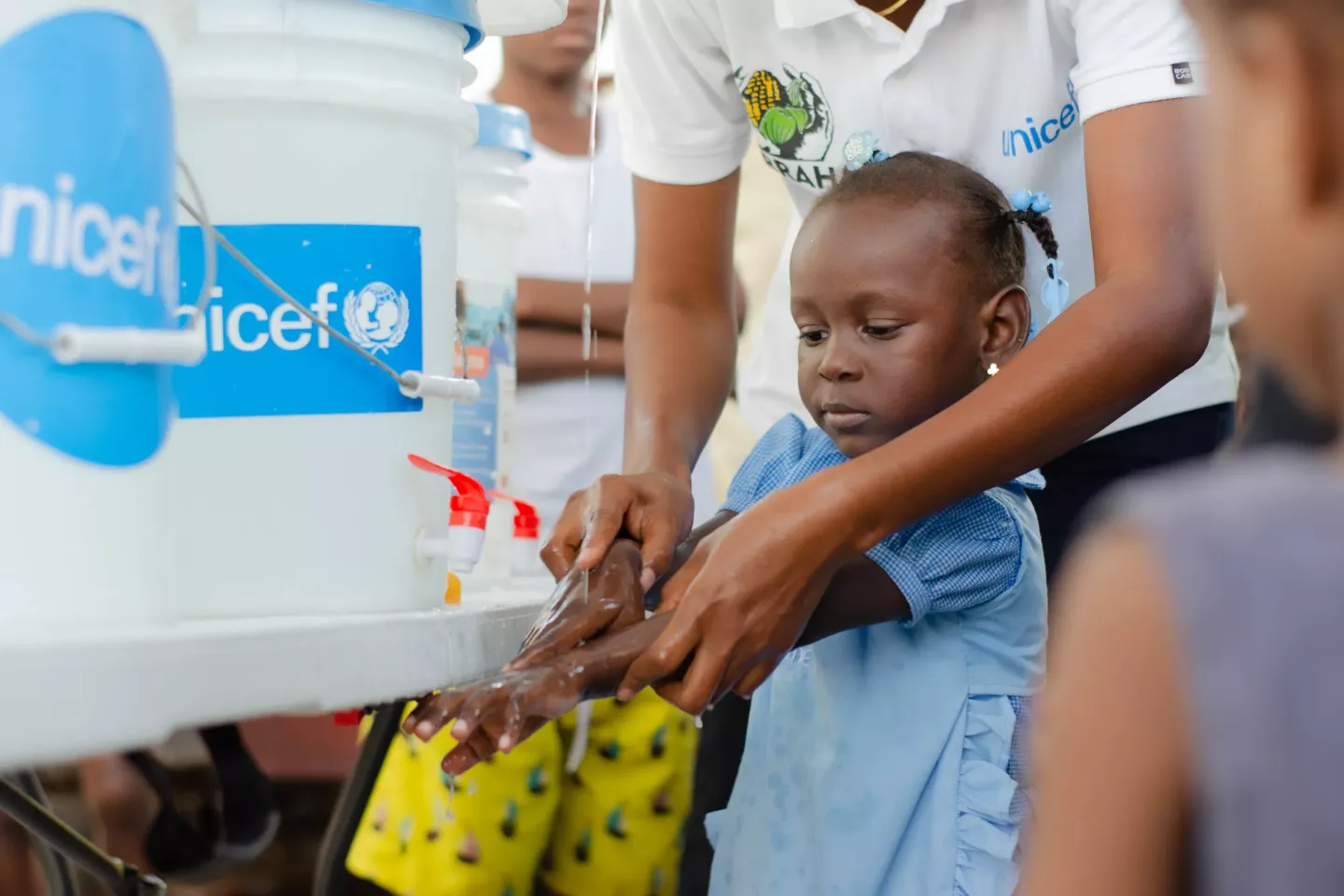 A child participating in a handwashing awareness session at the sites