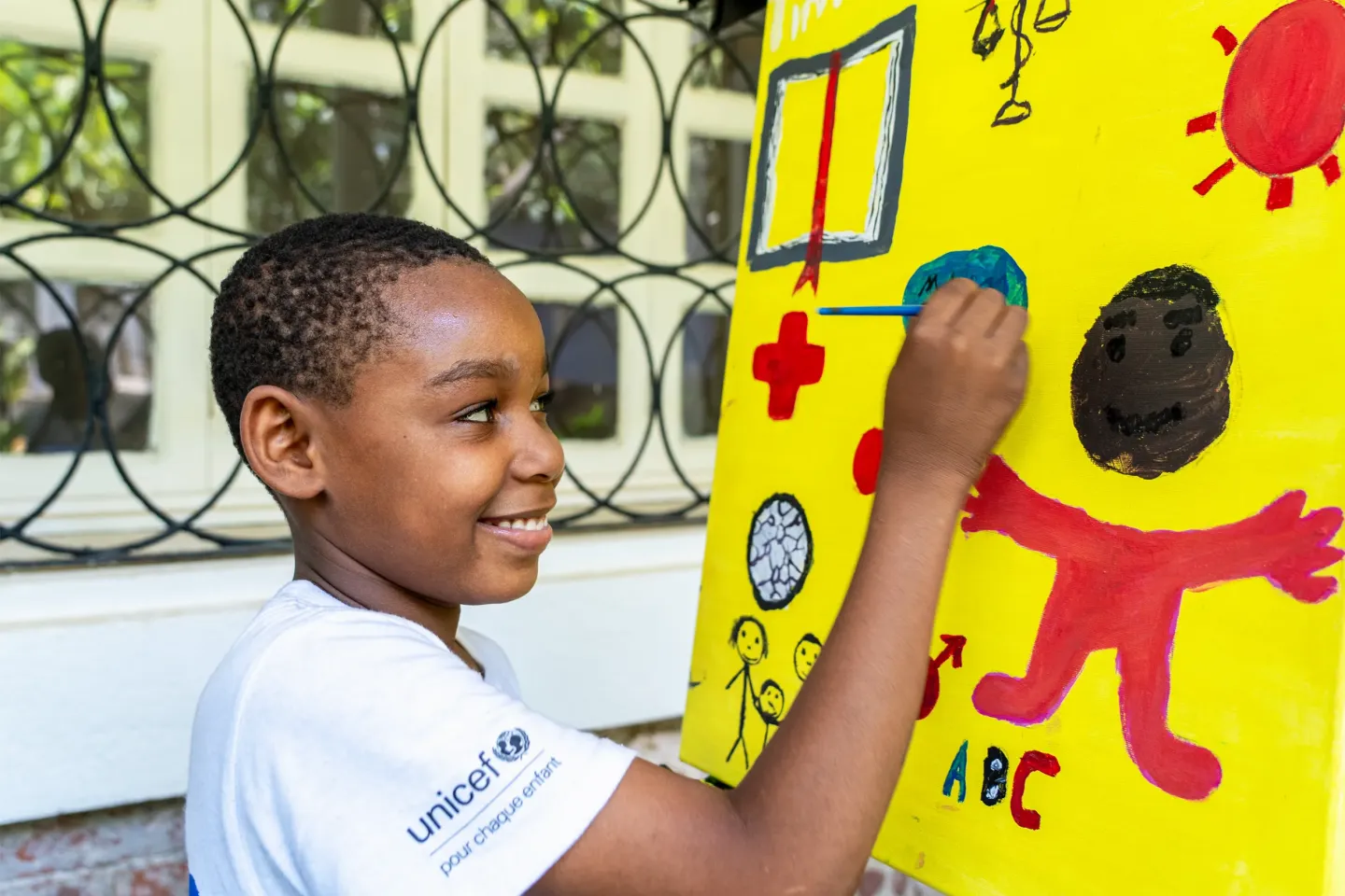A young boy painting