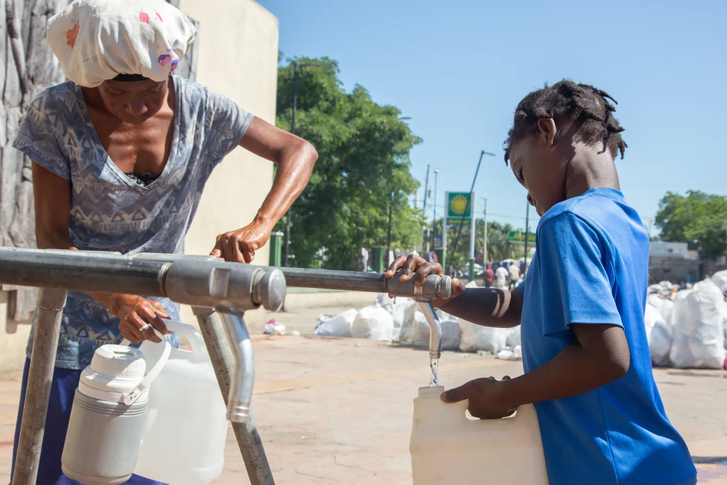 A family drawing water from a UNICEF-installed tap.