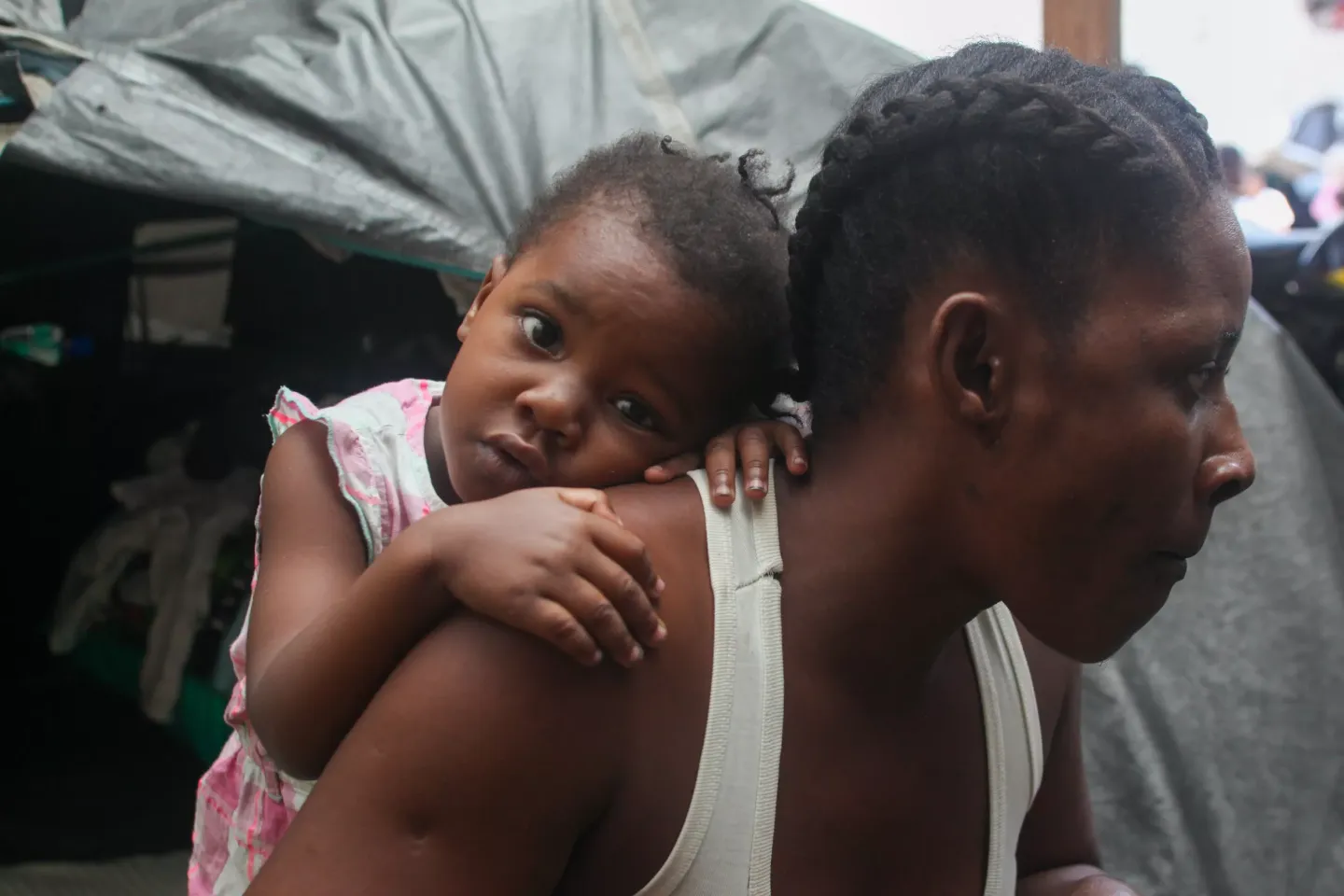 A child on her mother's back.