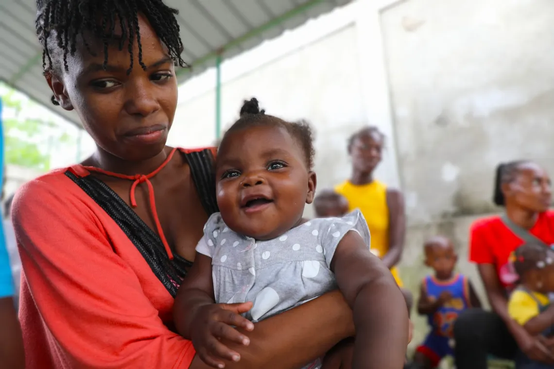 Mariana smiled in her mother's arms.