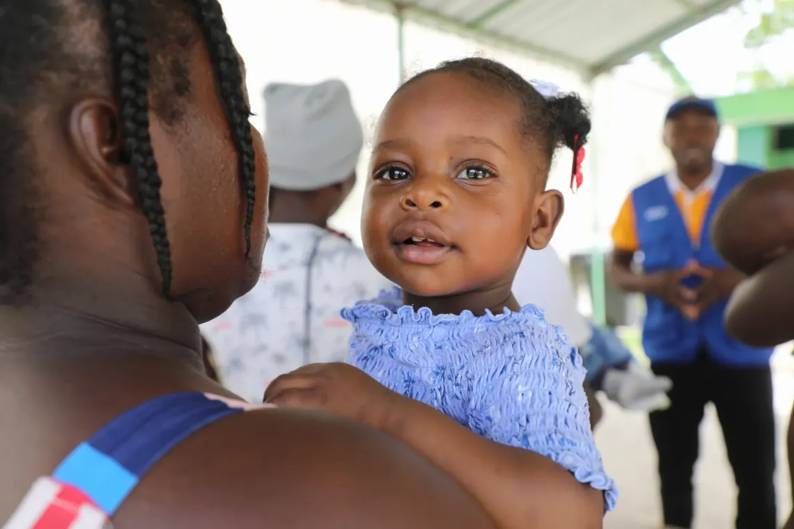 Anne-Chemaya, 12 months old, smiles after receiving her Vitamin A. 