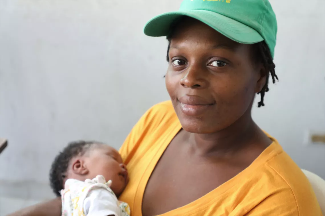 Marie is happy to have her child vaccinated.