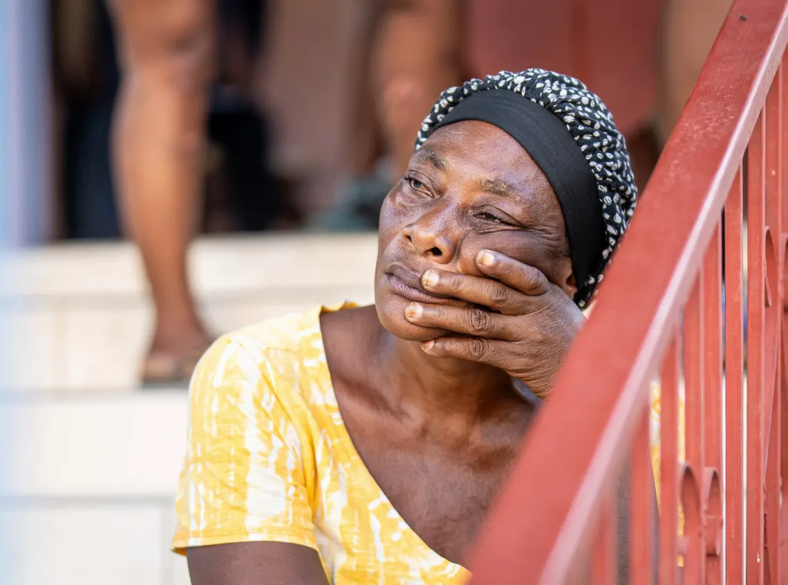 Marie-Rose, 59, in Petit-Go&acirc;ve, weeps for her children and her inability to visit her injured daughter in the hospital.