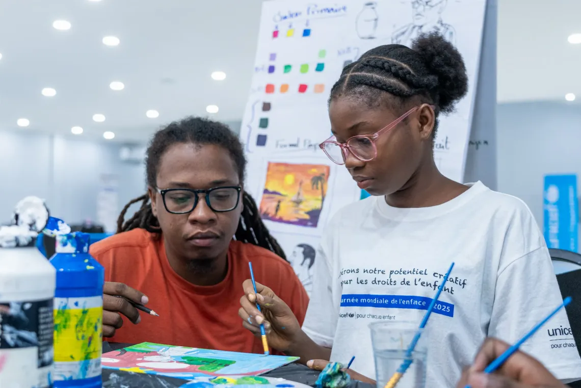 A young girl learning how to paint
