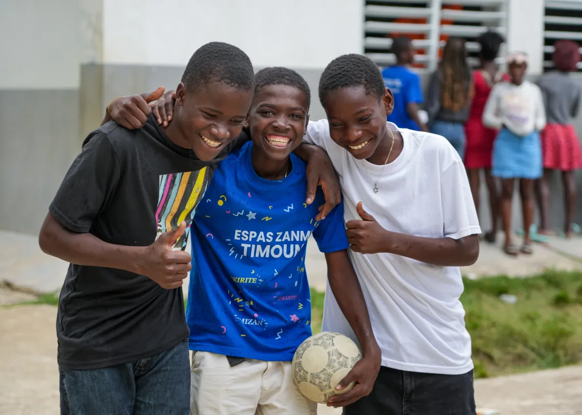 Three young boys smiling