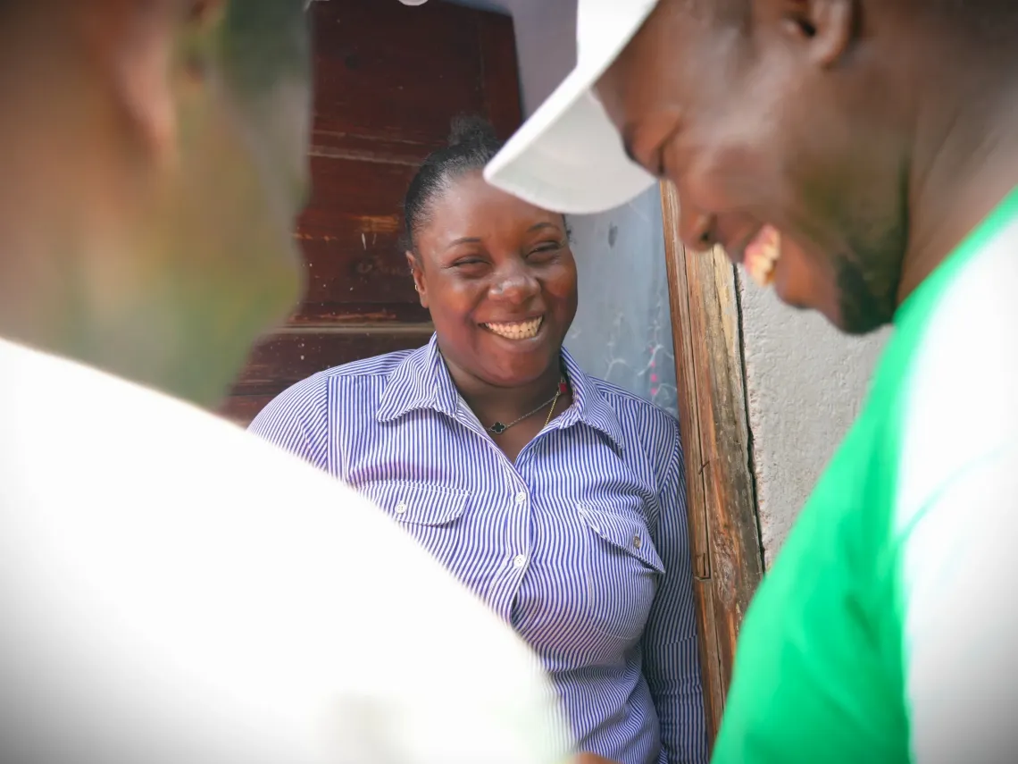A woman smiling while talking to a man