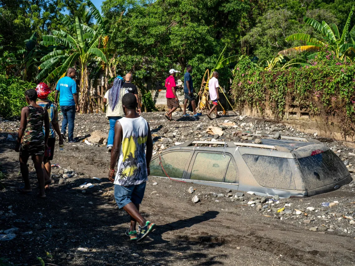 UNICEF staff assess the damage caused by Hurricane Melissa in Petit-Go&acirc;ve, where houses and vehicles lie buried under thick layers of mud. 
