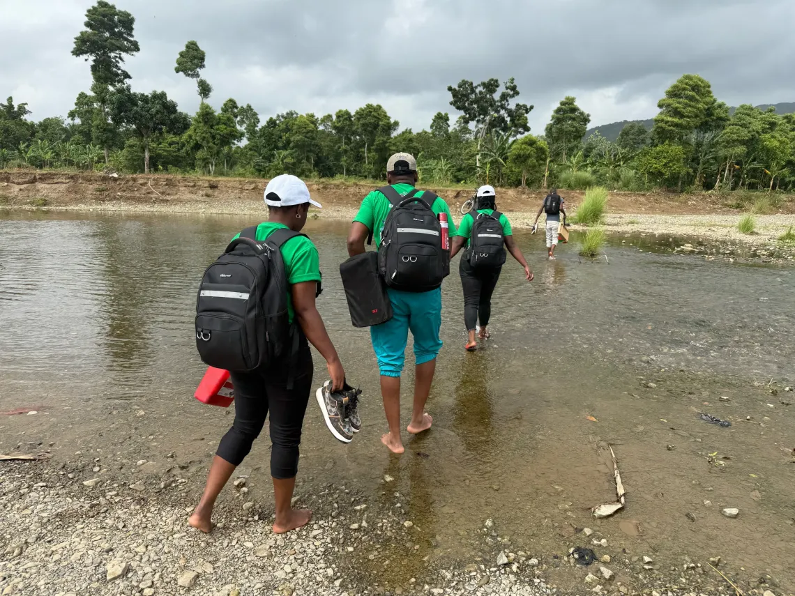 A group of people crossing a river