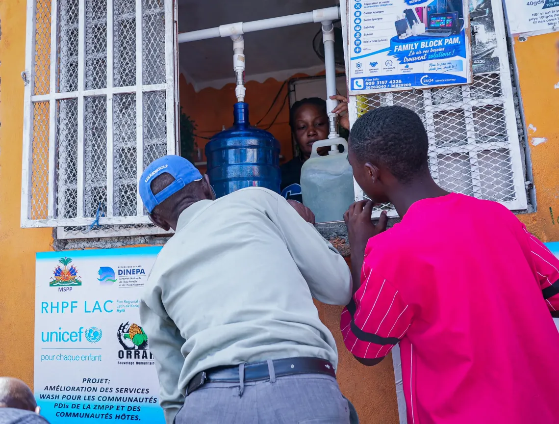 Residents collecting water at a water kiosk in Delmas