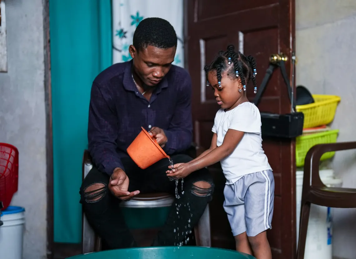 Jean-Guerson with his four-year-old daughter.
