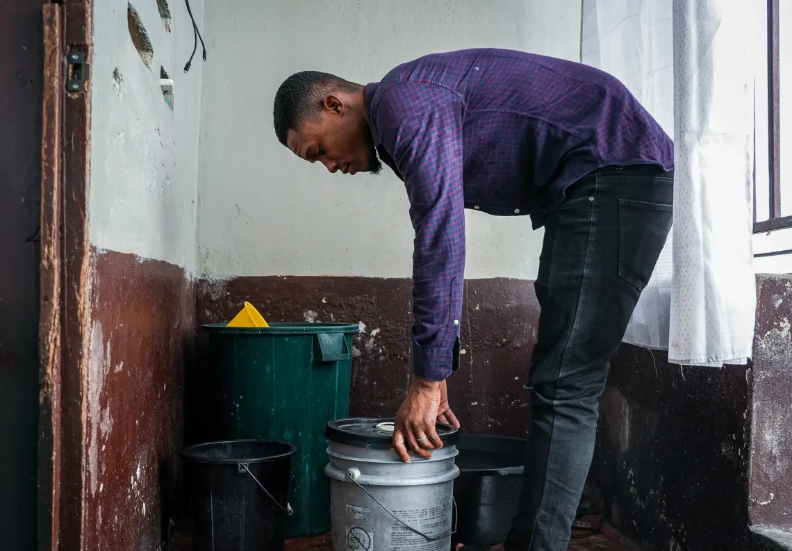 Jean-Guerson fills his container