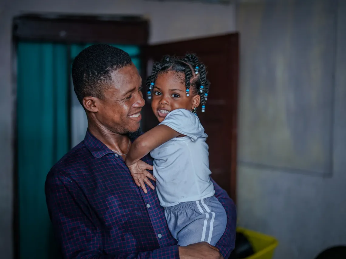 Jean-Guerson with his four-year-old daughter.