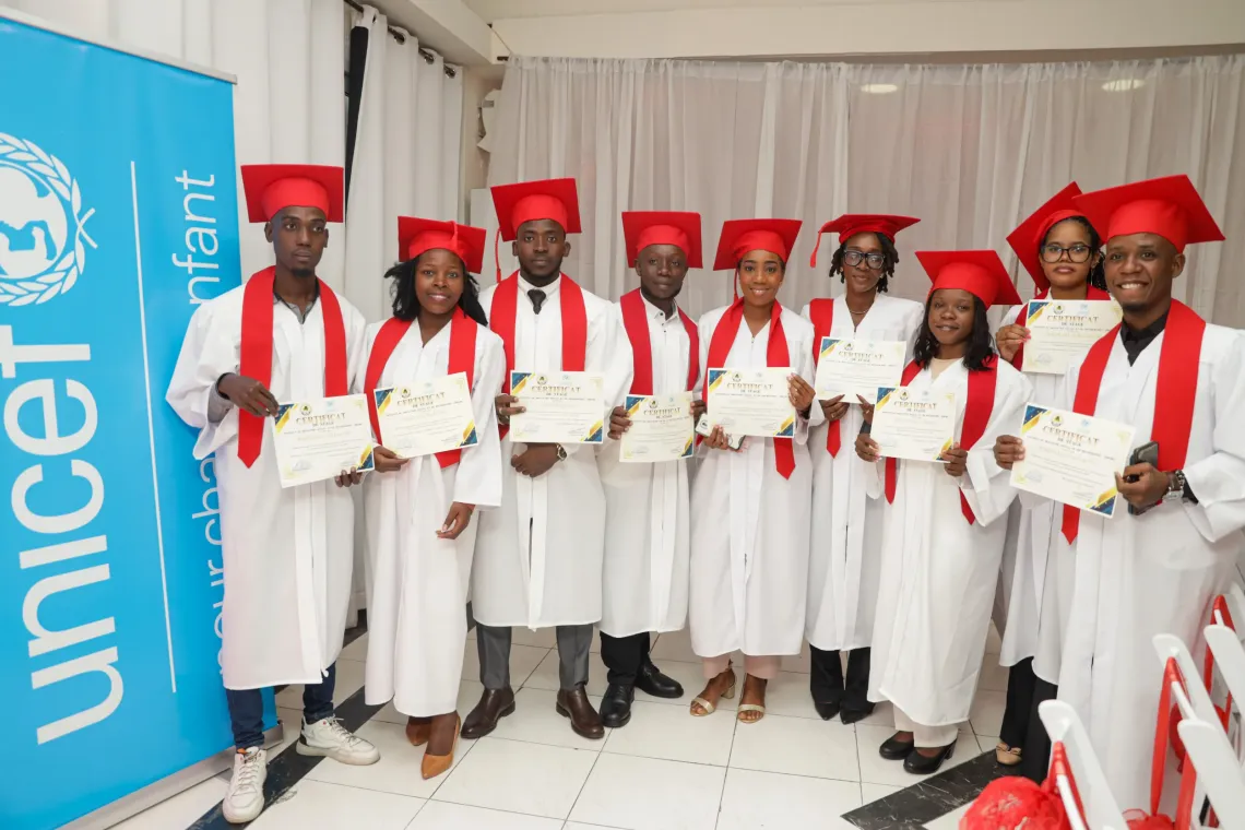 A group of young people pose for a photo with their certificates