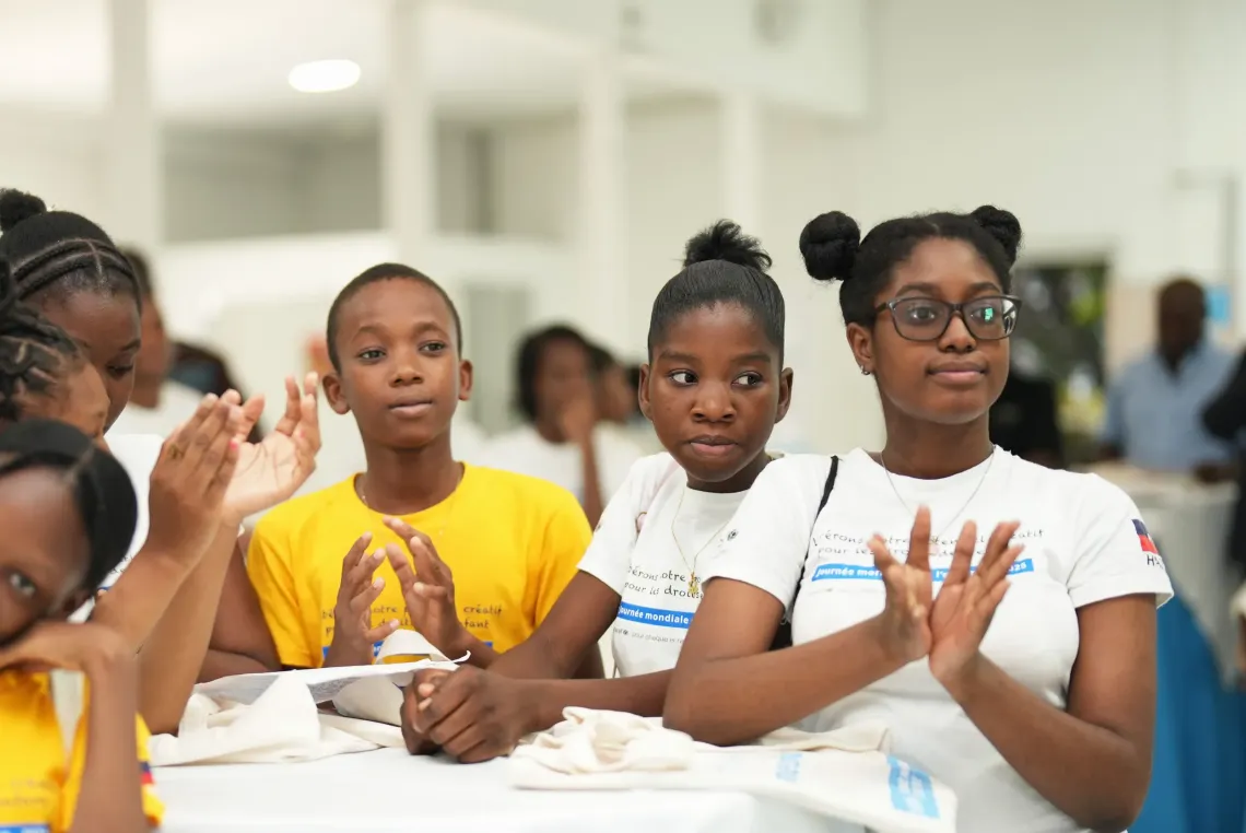 Children applauding and smiling