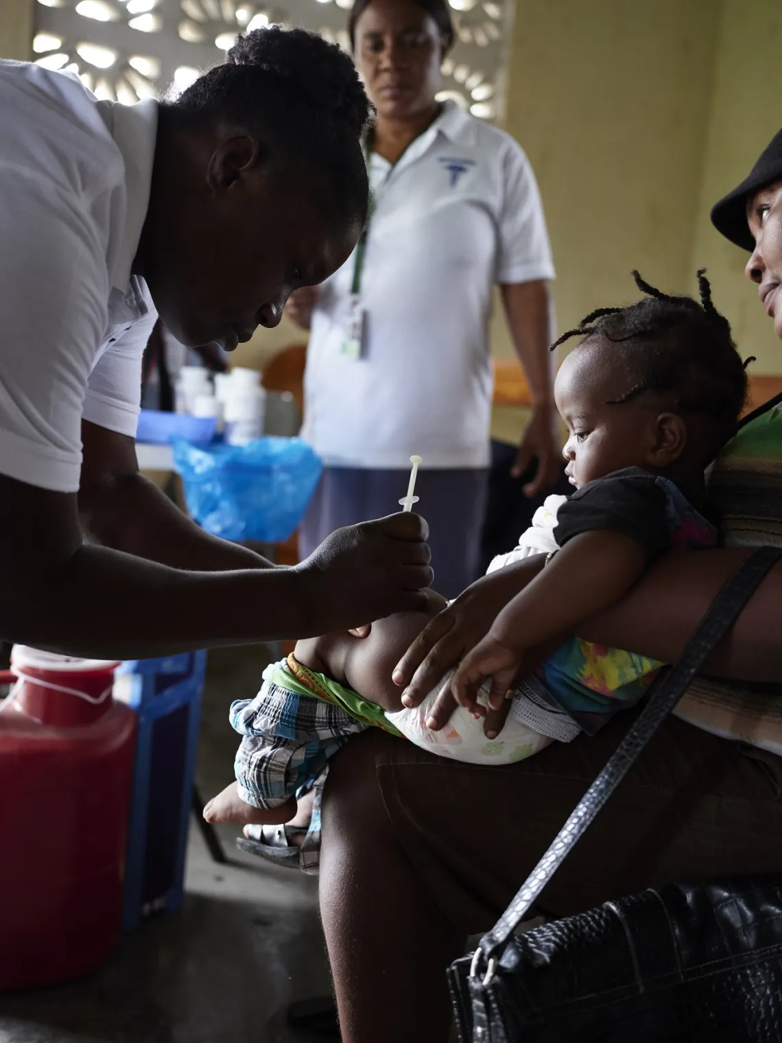 Davidson, 1 year old, being vaccinated in his mother arms 