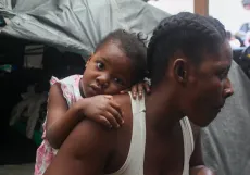 A child on her mother's back.