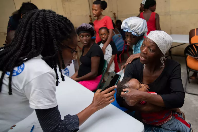 a mother brings her child to a mobile clinic for a consultation 