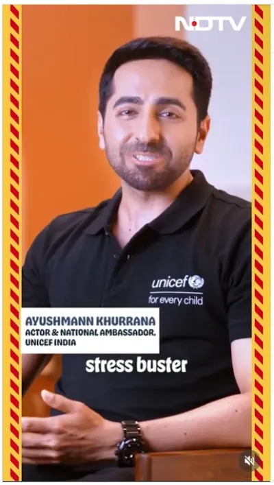 An NDTV video still of Ayushmann Khurrana, identified as Actor & National Ambassador UNICEF India, speaking on the topic of stress-busting, wearing a black UNICEF polo shirt.