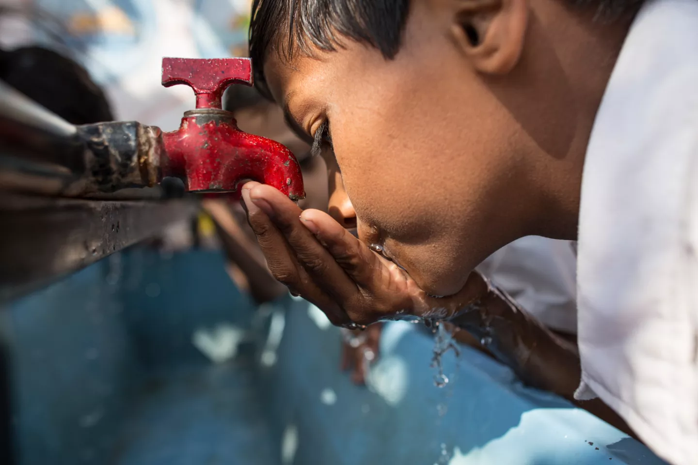 A child drinking water from water tab at his school in western Indian state of Maharashtra.