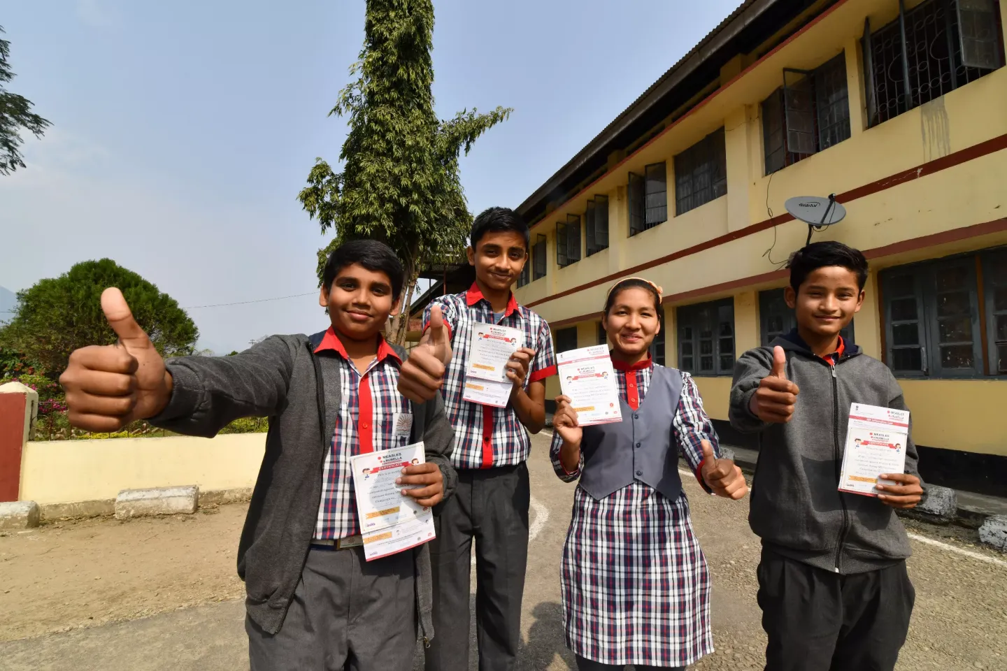 Students show their MRV card after a Measles Rubella vaccination session at Kendriya Vidyalaya School in Pasighat, in East Siang district, in India&Otilde;s north-eastern state of Arunachal Pradesh on February 24, 2018.