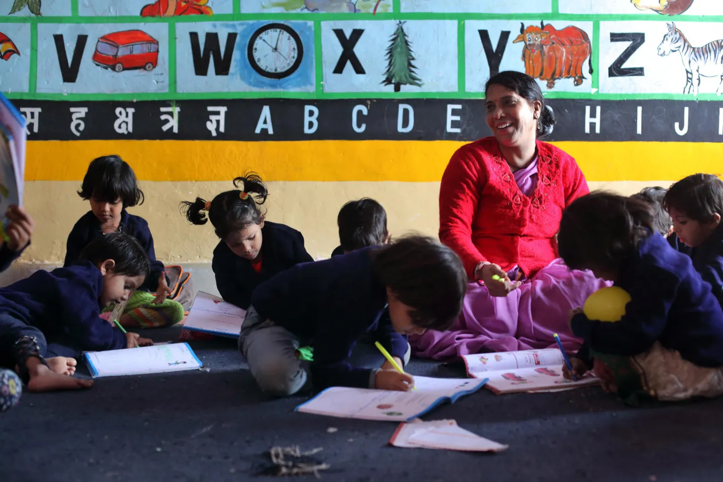 Teachers and children in a classroom.
