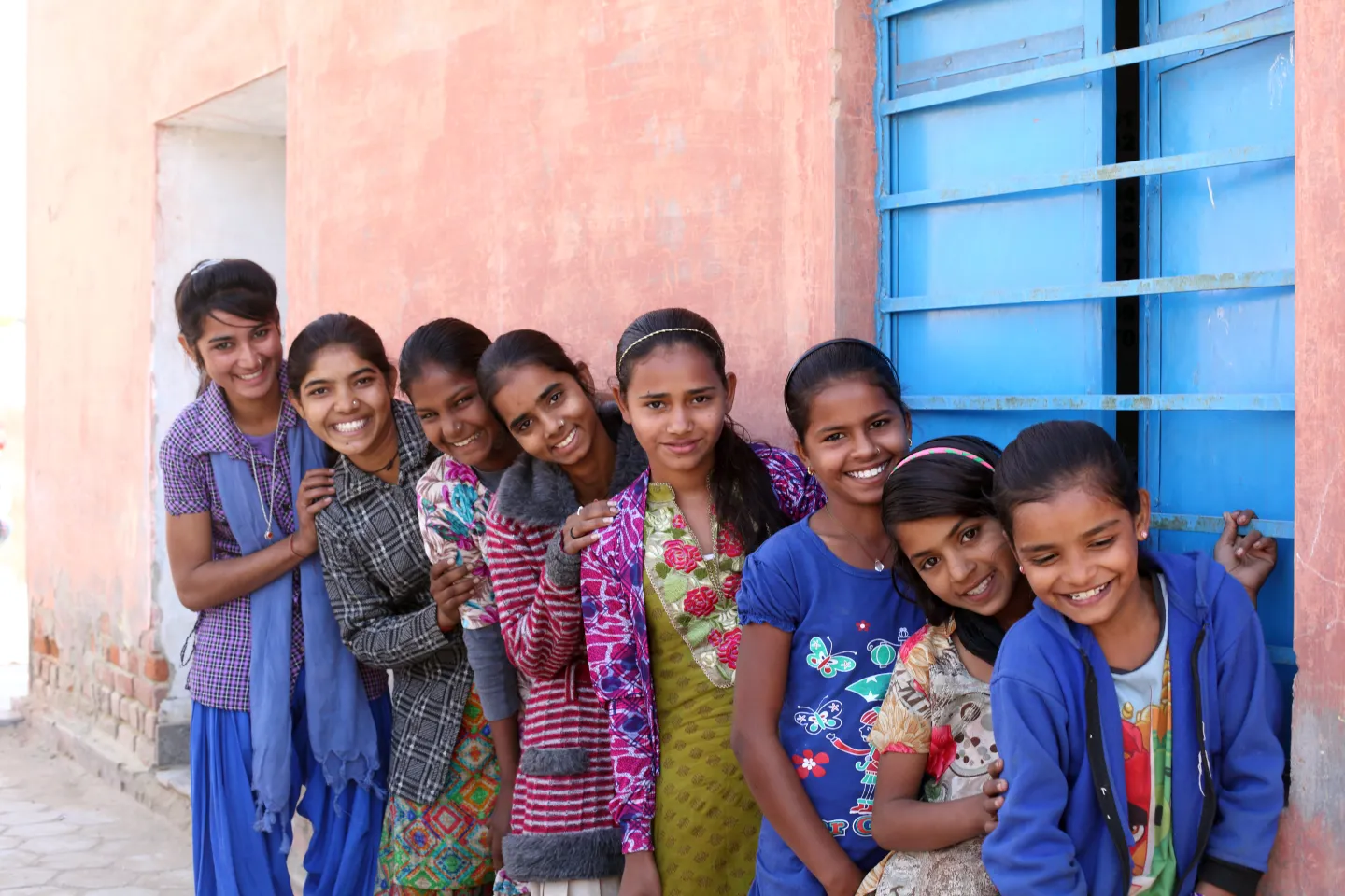 Young adolescent girls pose for a group photograph at the AGG meeting at the Anganwadi Centre, Husangar village, Sri Dungargarh block, Bikaner district, Rajasthan, India.
