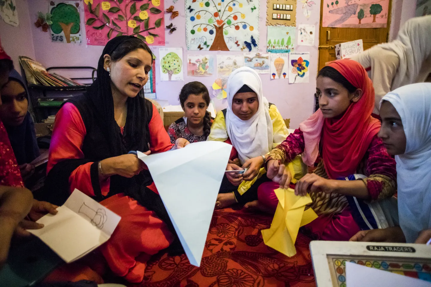 Children learn paper cutting during a session at the Child Friendly Space (CFS) in Pamposh colony of Srinagar in Jammu and Kashmir.