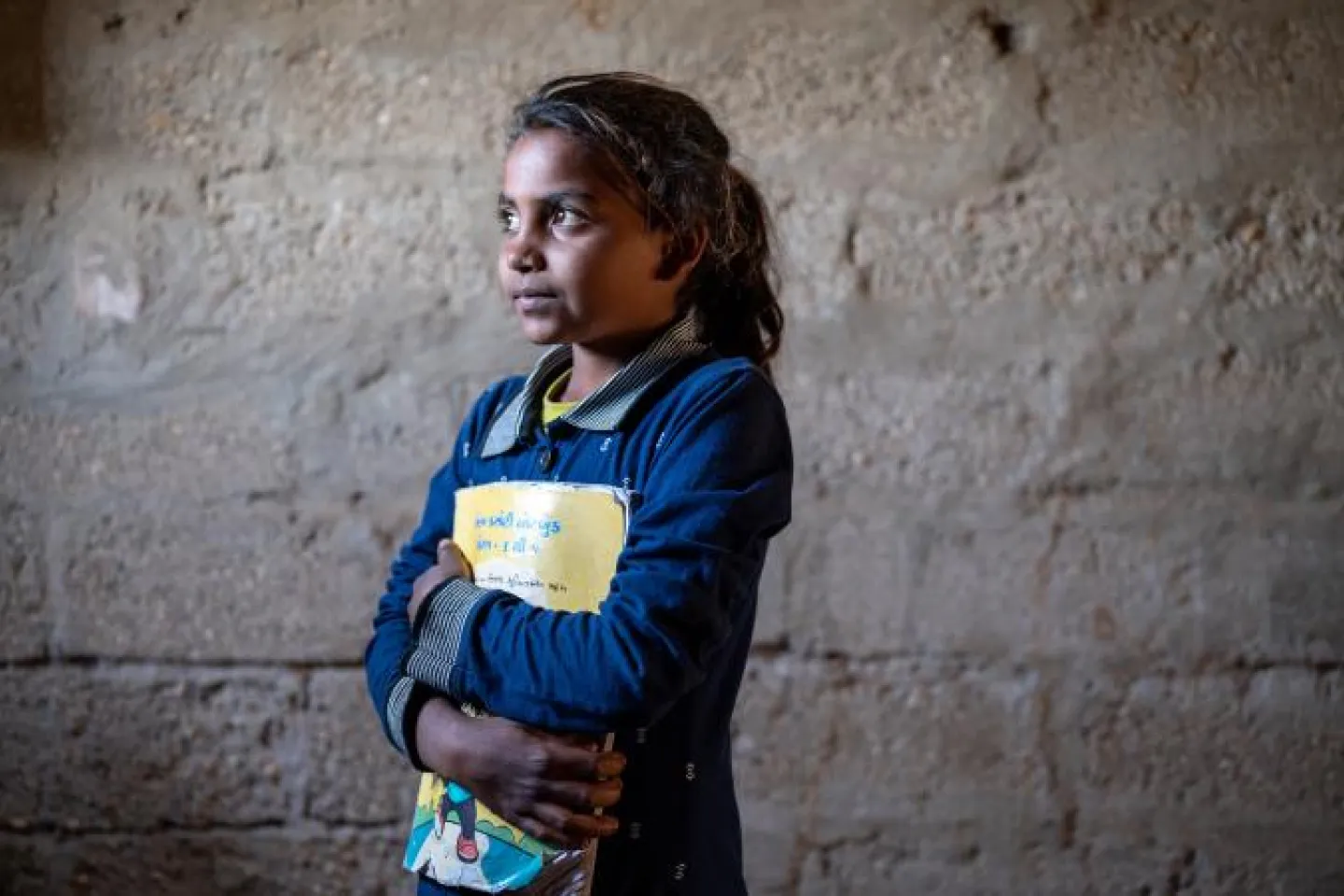 A girl holding a book.