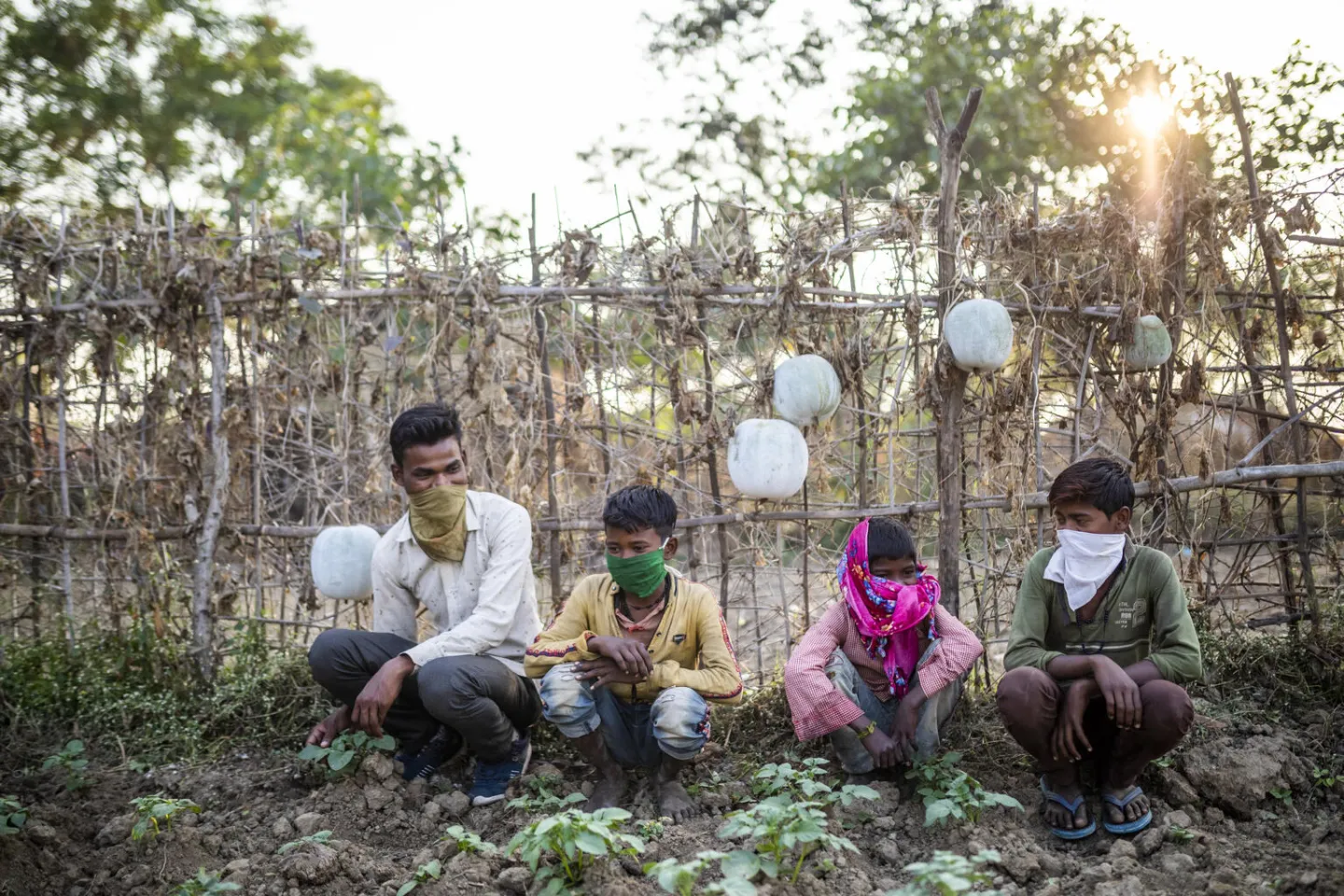Ajit Kumar reacts as he sits with children in a community kitchen garden at Amachur Nerua, Chitrakoot. 