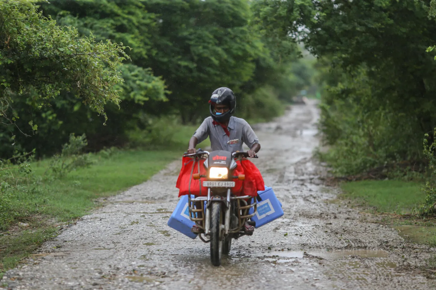 COVID-19 vaccines being transported by a health worker in Bihar