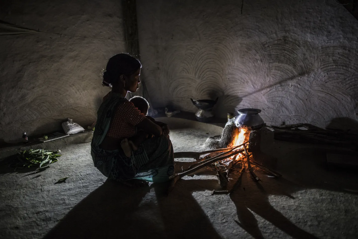 Fulashree Nirmal cookes evening meal inside her house in her village. 