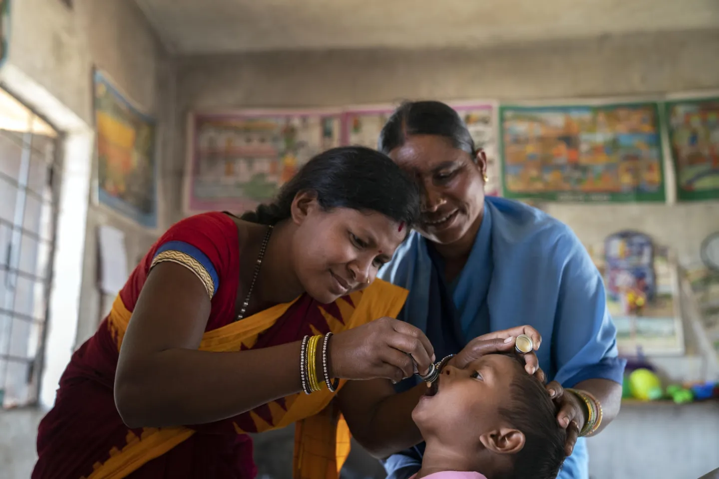 Vaccinators immunising children at an Anganwadi centre 