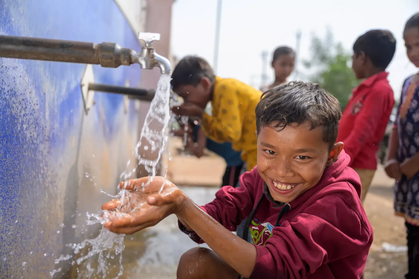 David &nbsp;(10) at drinking water station at the village. Location : Mohlai village, Durg, Chattisgarh.