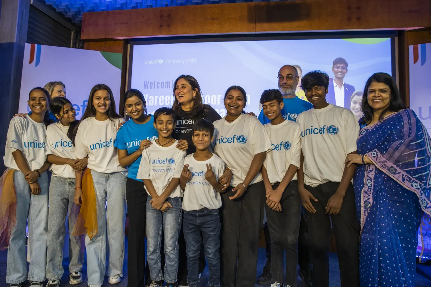 Kareena Kapoor Khan poses with a group of young UNICEF India children and youth advocates at her official welcome event as UNICEF National Ambassador, alongside UNICEF officials and a woman in a blue saree.