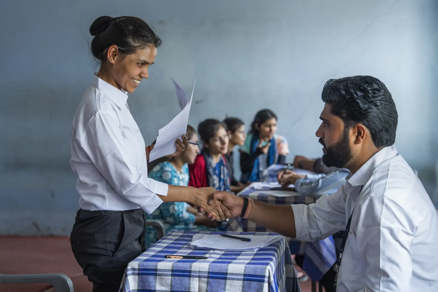 Monika shakes hands with an employer at a Job Fair in Rajasthan