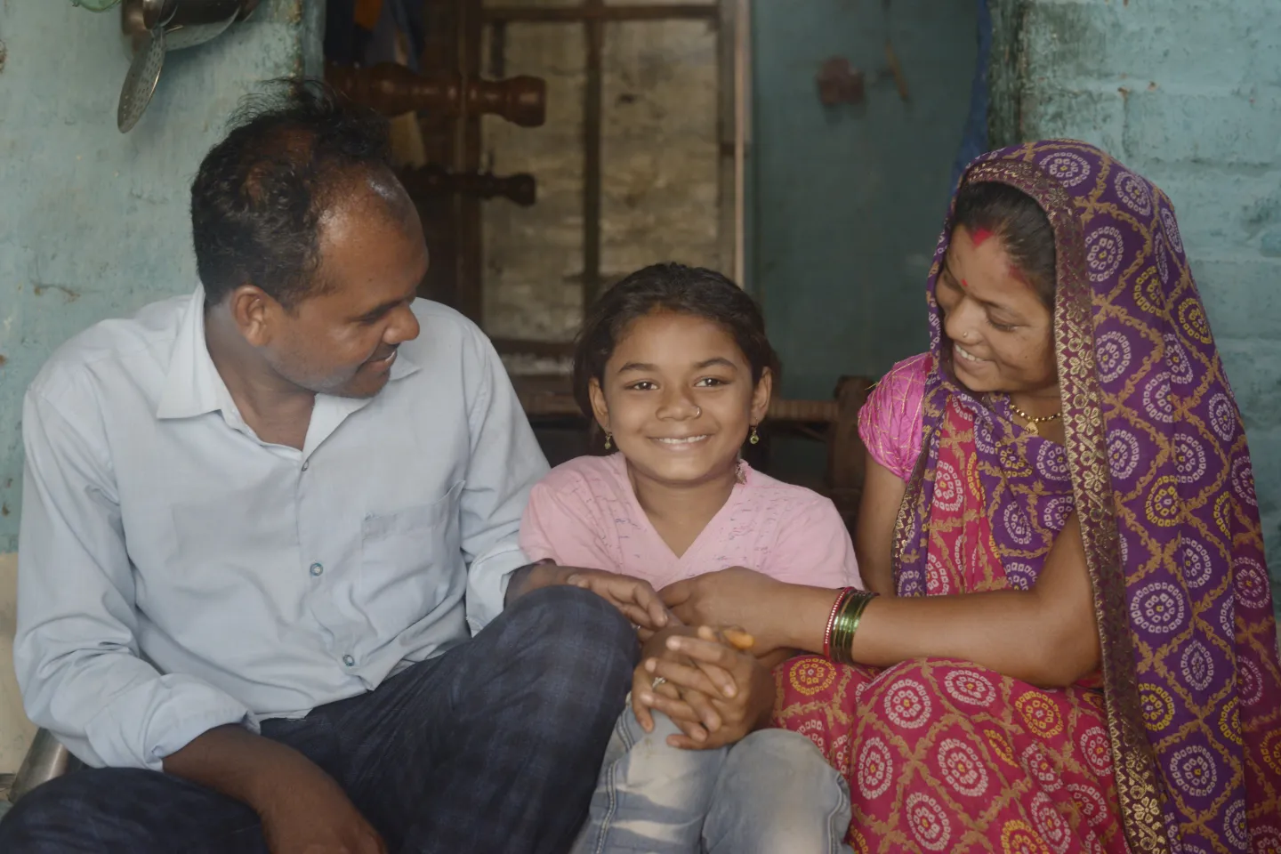Parents enjoying a light moment with their child