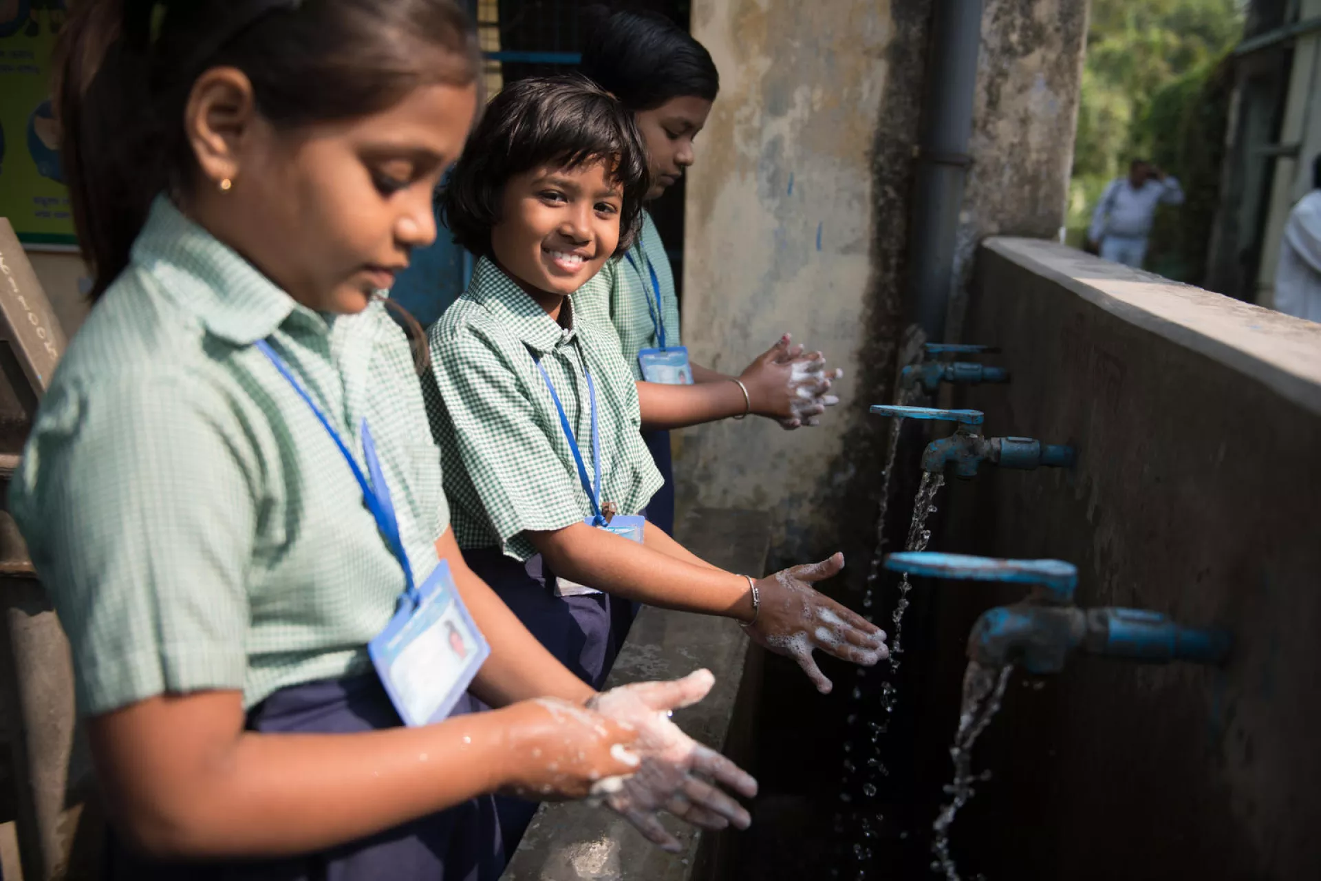 Students wash their hands in Purba Simla School.
