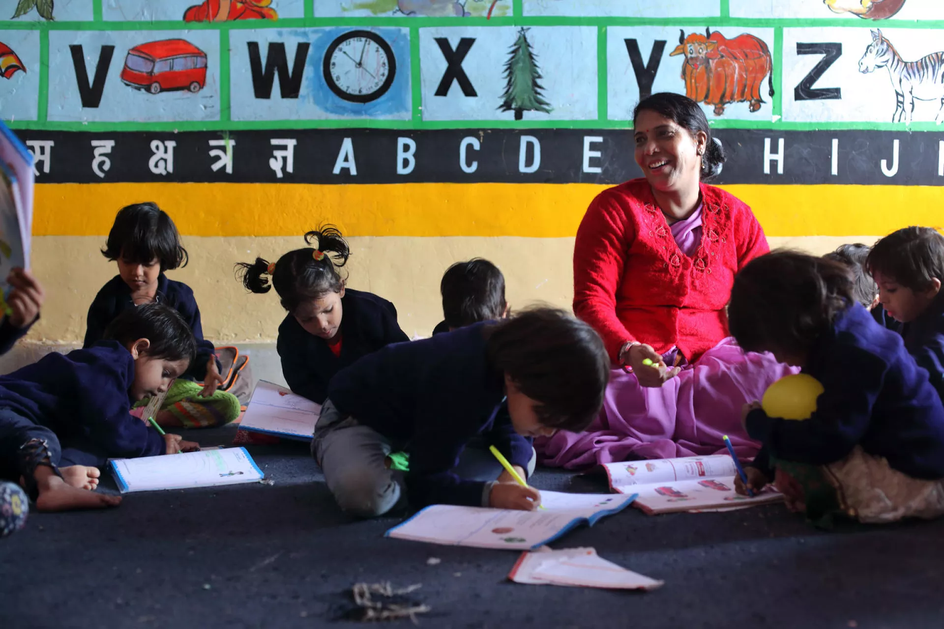 Teachers and children in a classroom.