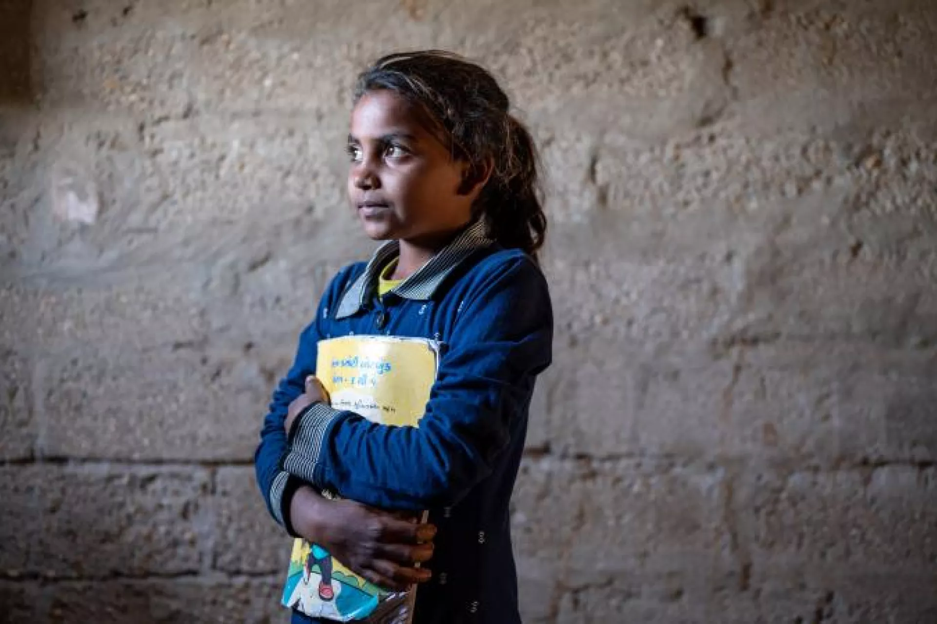 A girl holding a book.