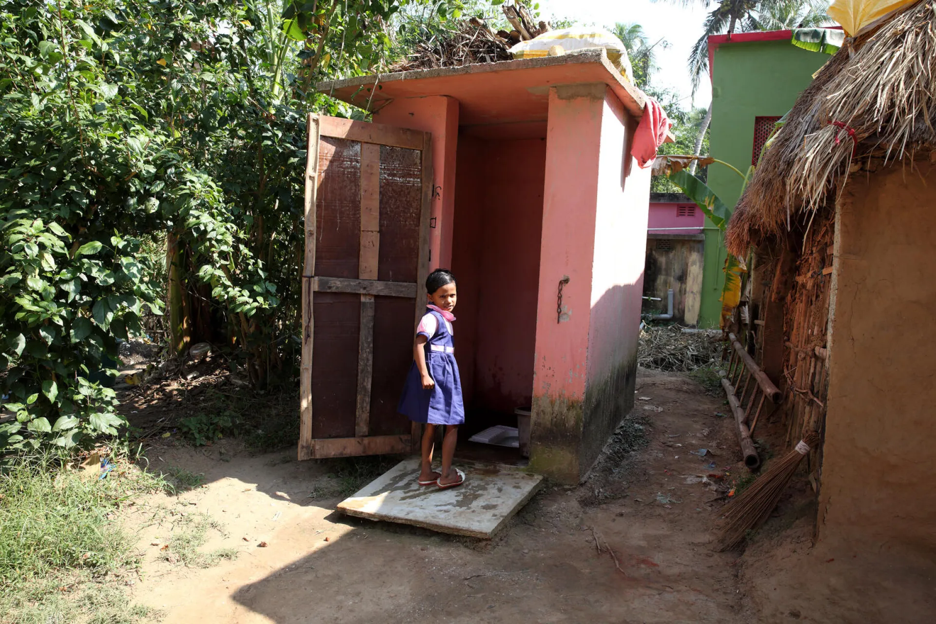 A young girl uses her toilet at home, Raghunathpur, Kujang, Jagatsinghpur, Odisha