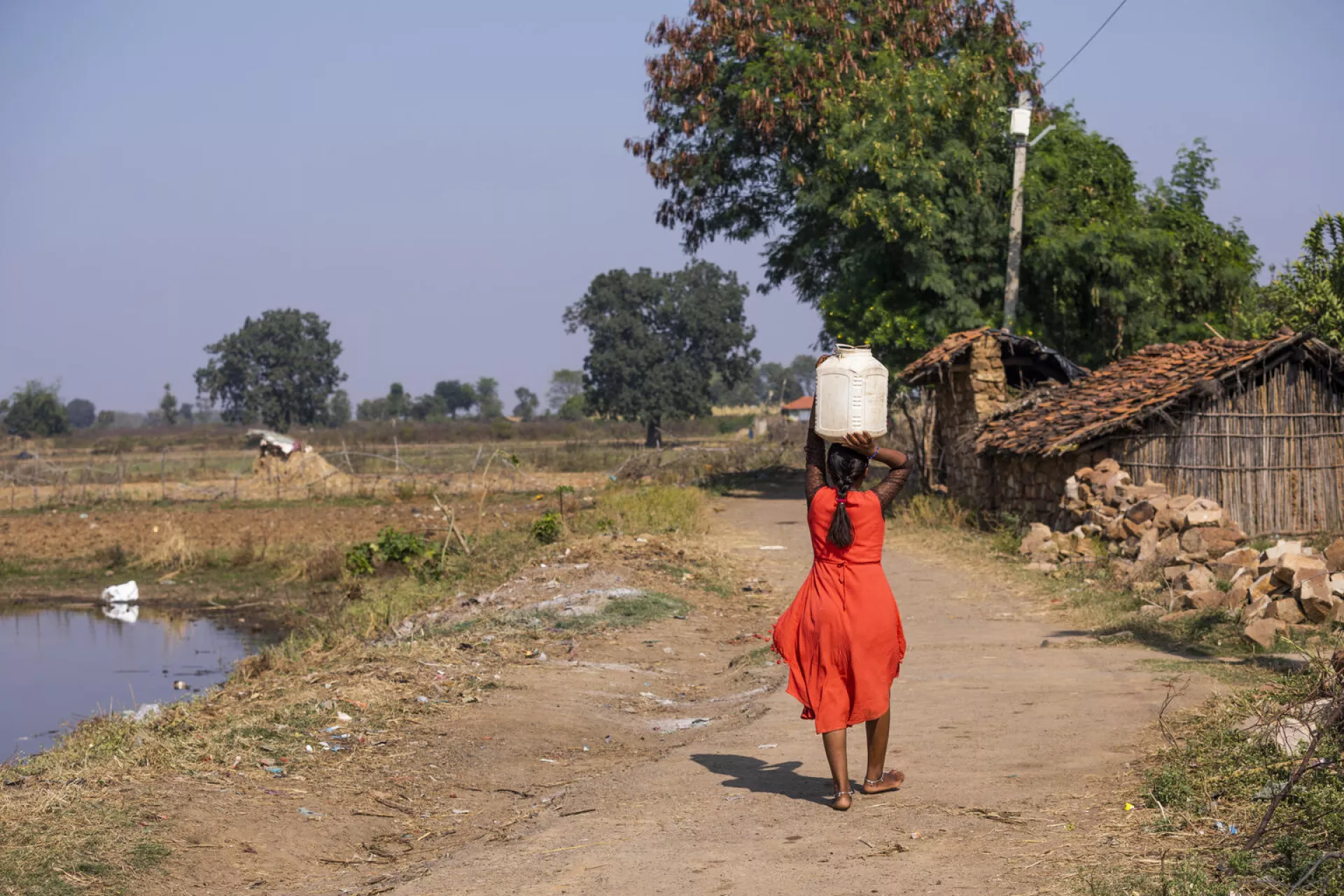 People collect water from a closed sanitary well created by UNICEF reducing the time to get water from their house from few hours to a few minutes, in Jamunhai, Chitrakoot.