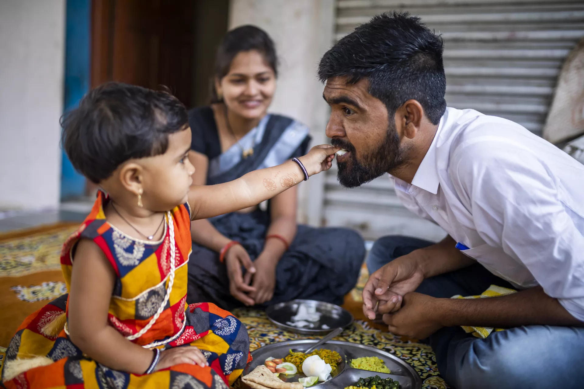 30 years old Yogesh Kulkarni and 23 years old Prateeksha feed nutritious food to their 2 years old daughter at their house in Karmad, Aurangabad.