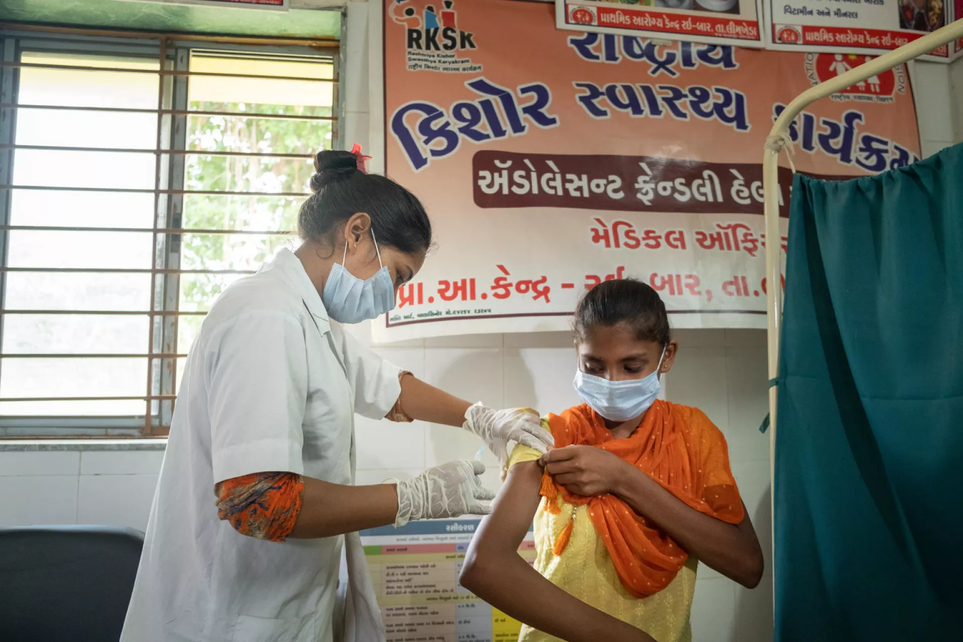 Staff nurse Darshna Ravatgiving TD vaccine to Savitri (16) at Adolocent friendly clinic at PHC conducted by PHC staff.