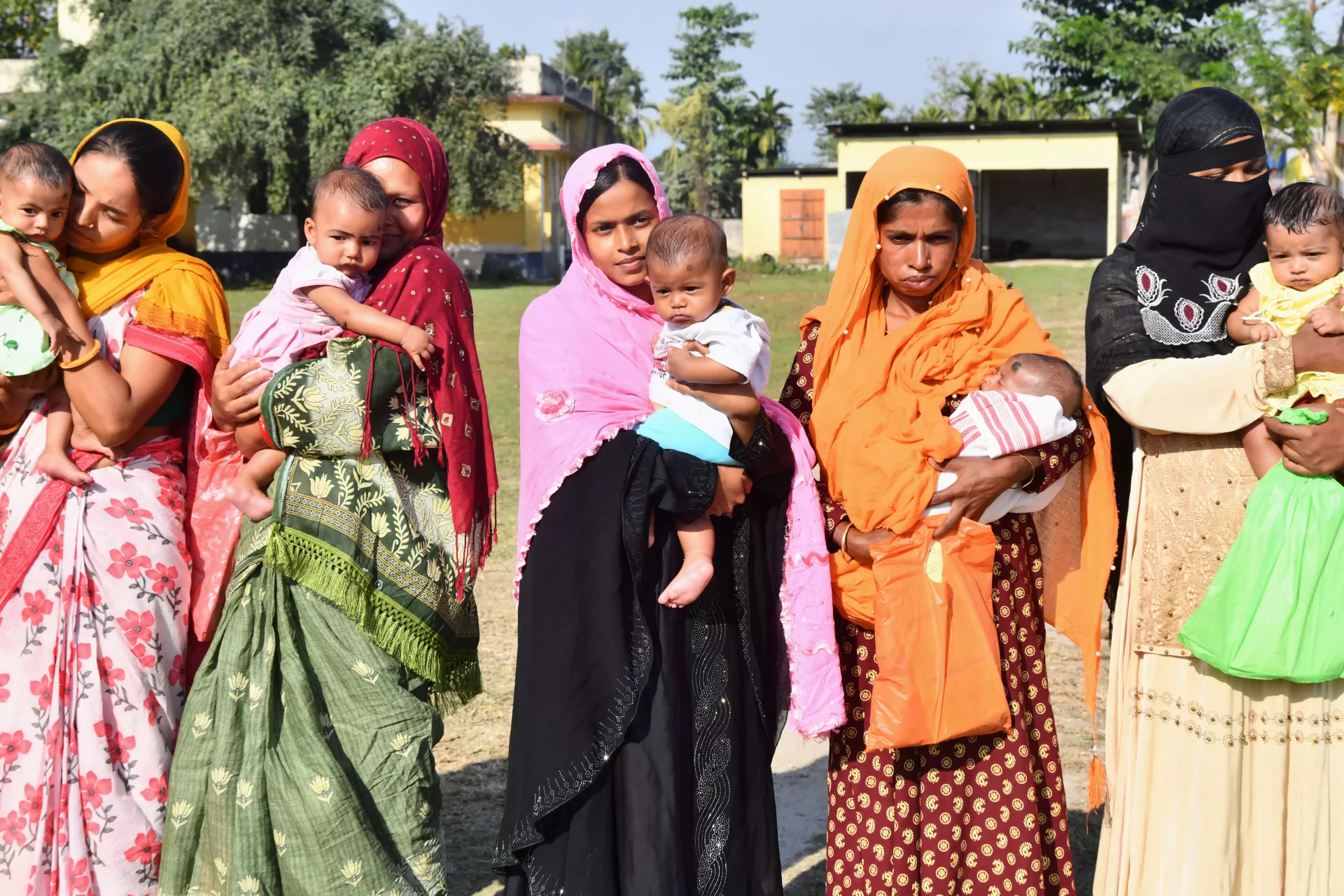 women and their children pose after the routine immunization (RI) sessions &nbsp;at Kuwari Pukhuri Sub Centre in Darrang district.