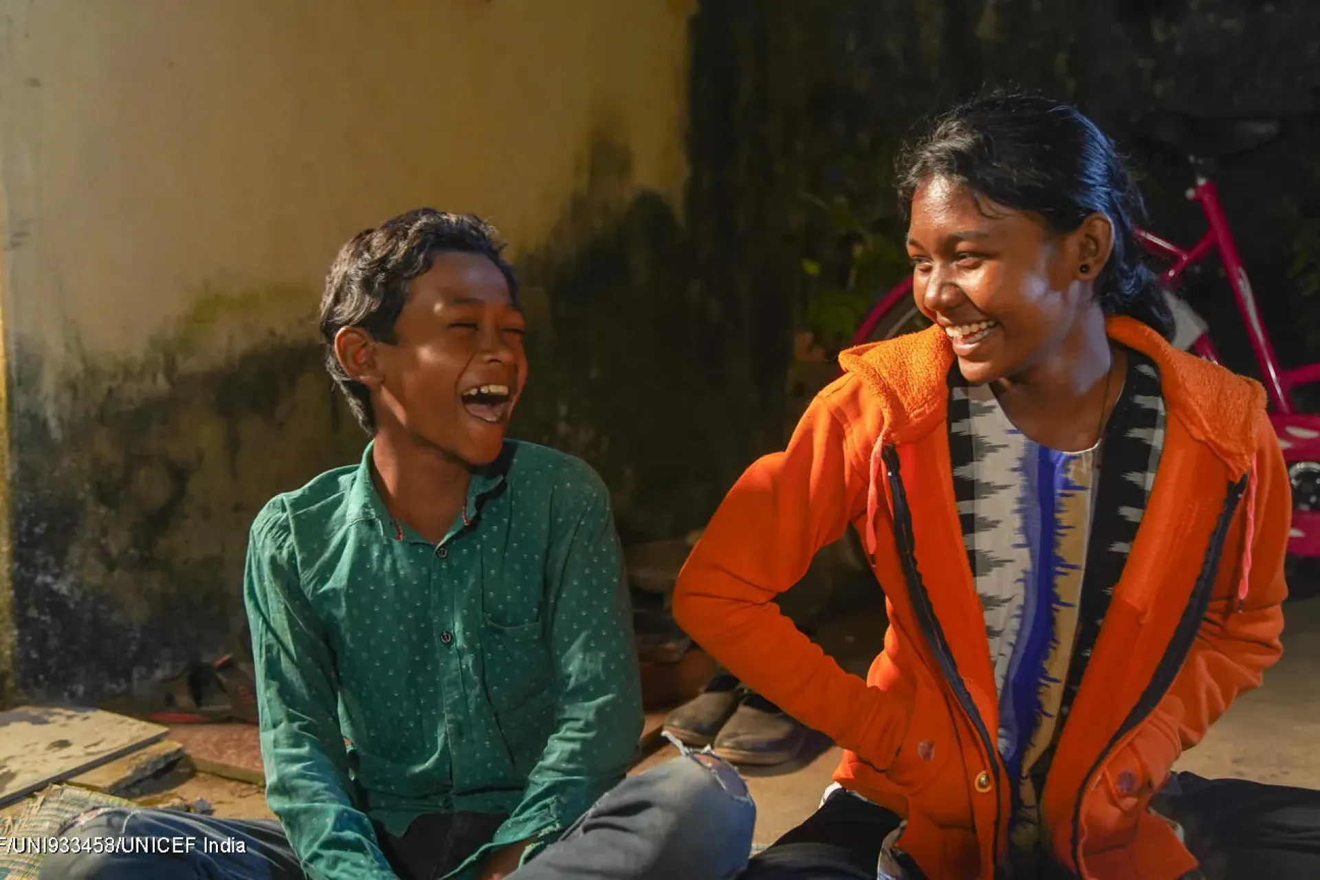 Siblings laugh and smile in their presence
