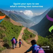 Children with school backpacks walking along a mountain trail toward a valley town, with the UNICEF &amp;quot;for every child&amp;quot; logo and the teaser text &amp;quot;Squint your eyes to see what's coming next tomorrow.&amp;quot;