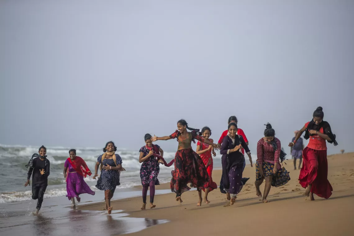 A group of new Advika members enjoy day on the beach