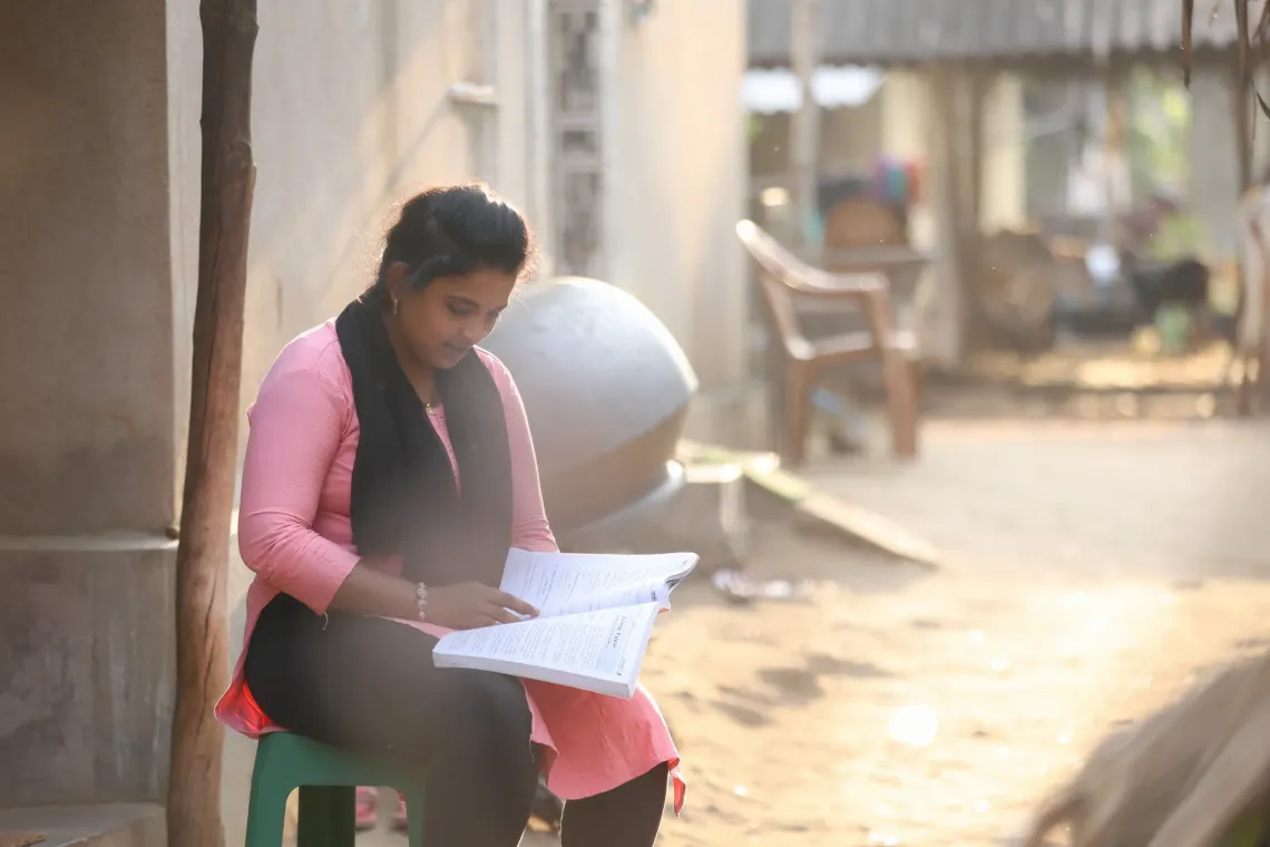 Priti Sahu sits and studies her learning material in her free time