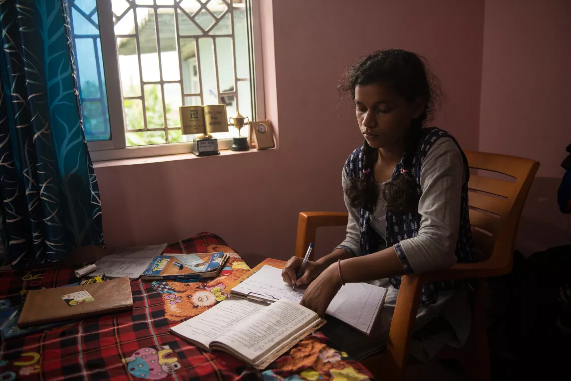 Kusma Kumari studies in her home in Kanke block of Ranchi in the central Indian state of Jharkhand.